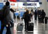 Holiday air travel surges despite dire health warnings