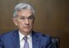 Fed keeps rate near zero and sees brighter economy in 2021