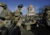 Small numbers of protesters gather at fortified U.S. capitols
