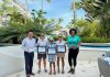 The Aruba Tourism Authority honor loyal visitors on the island; Melissa Schmitt, Laura Piucci, and Xavier Piucci