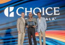 Radisson Blu Aruba’s Luigi Wix Named Choice Hotels’ General Manager of the Year A group of men standing on stage with a large sign Description automatically generated