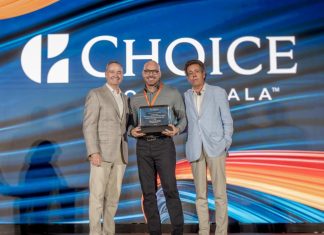 Radisson Blu Aruba’s Luigi Wix Named Choice Hotels’ General Manager of the Year A group of men standing on stage with a large sign Description automatically generated