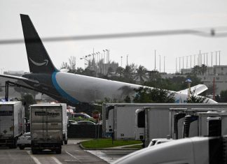 Amazon cargo plane overshoots Miami runway, hits vehicles, catches fire